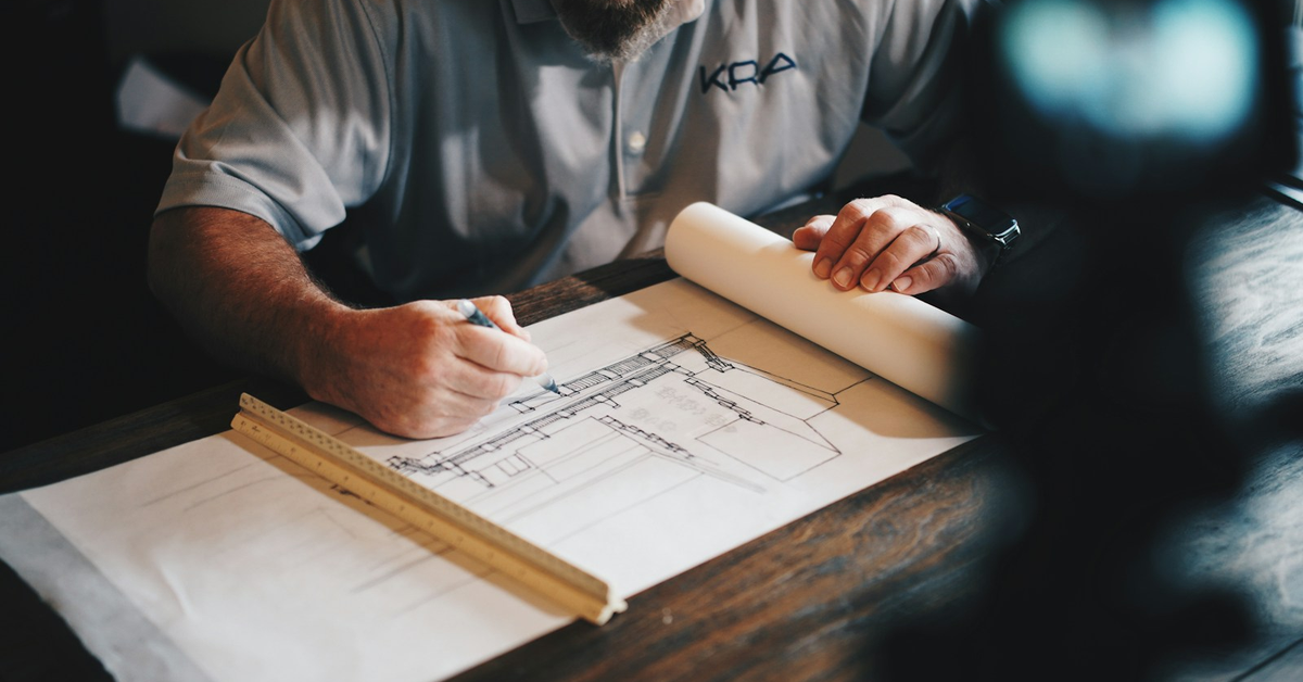Architect reviewing house construction plans and documents for a Bangalore home project